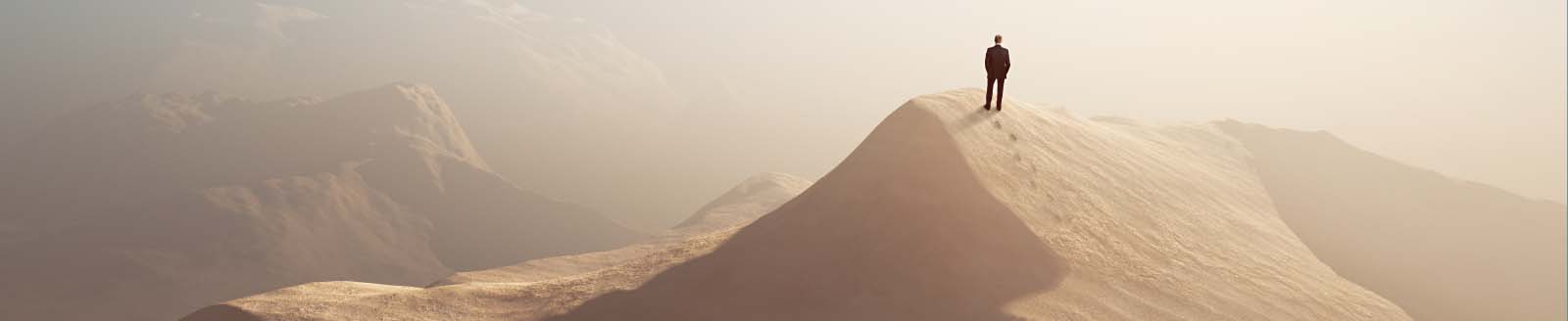 man alone on a desert hill