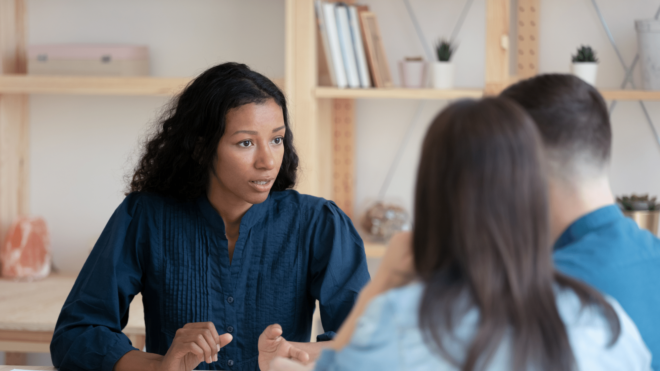 two young adults being counseled by a third