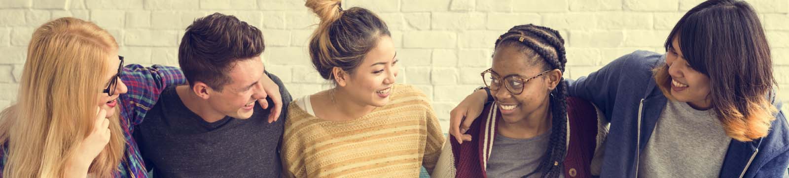 young adults with varying ethnicity smiling and happy