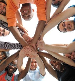 teenagers with hands together showing teamwork